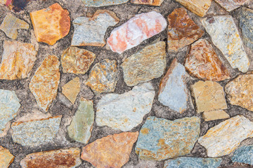 Color stone in the cement wall for background texture.