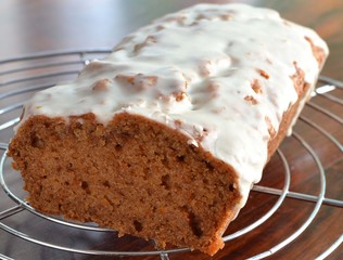 Iced vegan carrot cake on cooling rack