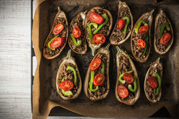 Stuffed eggplants  with vegetables on the baking tray top view