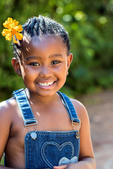 Cute african girl with flower in hair.