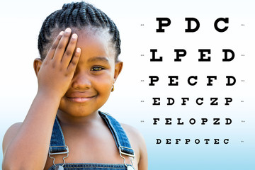 Little african girl testing eyesight.