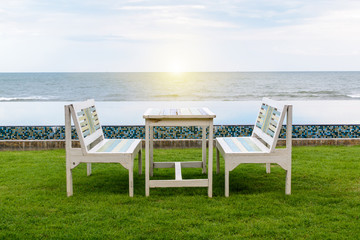 table and chair, swimming pool and the beach with sunlight