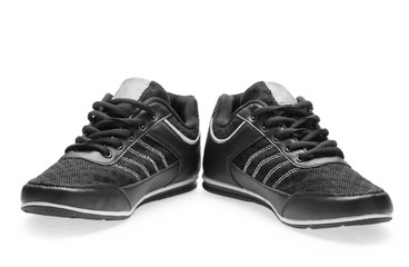 A pair of black sports shoes with shoelace