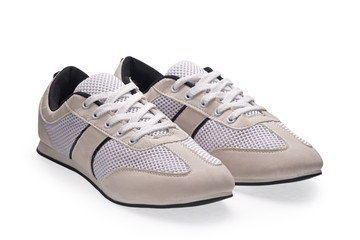 A pair of white sports shoes with shoelace