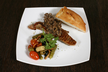 appetizer of grilled meat with mushrooms and vegetables