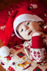 kid in christmas dress lying on cushions