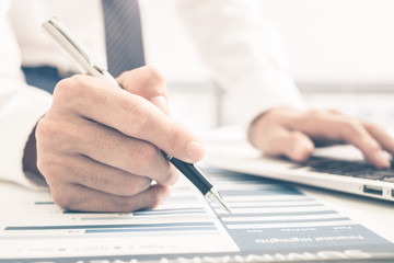 Fototapeta premium Man Analysis Business Report. Accounting