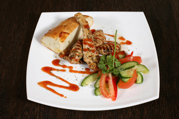 appetizer of grilled meat in sauce and vegetables