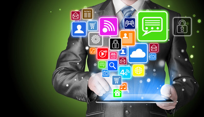 Business man using tablet PC with social media icon set
