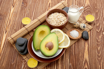 Fresh avocado on cutting board over wooden background