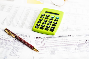 Business work station with paperwork income tax return, calculat