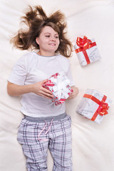 Woman with gifts on bed