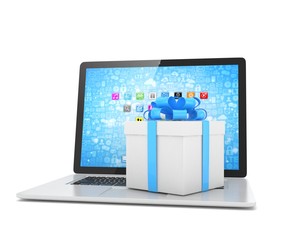 Gift box with ribbon bow on laptop keyboard