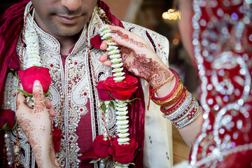 bBride adjusting grooms garland