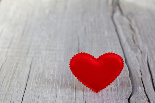 Red heart on a wooden background
