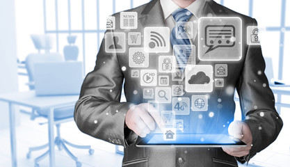 Business man using tablet PC with social media icon set