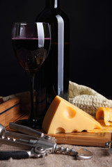 Cheese with holes and a glass of wine..