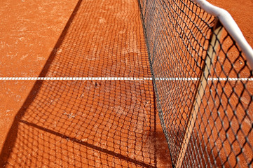 Tennis net detail on clay court