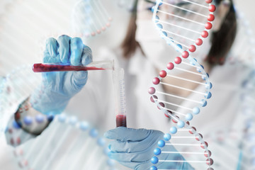close up of scientist with tube making test in lab