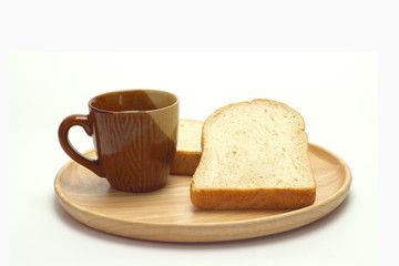 Wheat bread and cup of coffee on a white background