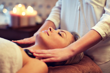 Fototapeta na wymiar close up of woman having hot stone massage in spa