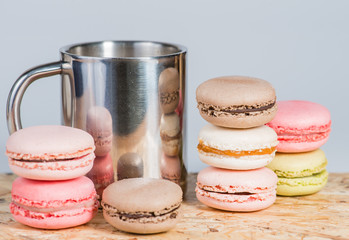 Cup and macaroon on a wooden surface (Shallow DOF)