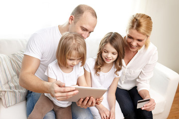 happy family with tablet pc and credit card