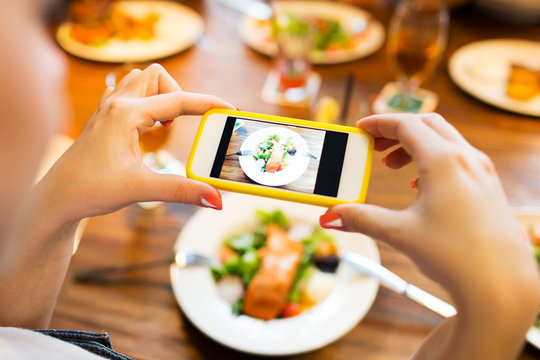 hands photographing food by smartphone 