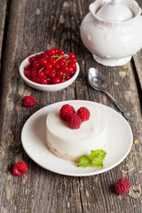 cheesecake with fresh raspberries and mint leaves