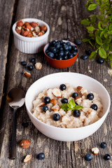 Bowl of oatmeal porridge with blueberry and mint