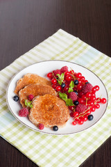 sweet cheese pancakes with fresh berries and milk