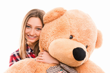 Cute young tenage girl hugs her teddy bear
