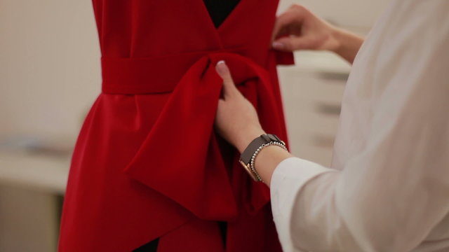 Fashion designer clothes maker draping dummy in studio.Fashion designer, tailor, dressmaker adjusting clothes on tailoring mannequin.