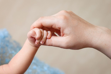 Newborn children's hand in mother hand. Mom and her Child. Happy