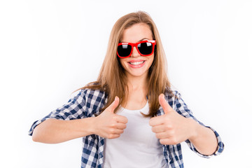 Happy girl in glasses with a red rim showing thumbs up