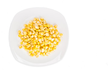 Overhead view of fresh corn maize kernels on plate