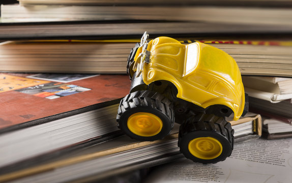 cars climbing on a pile of books