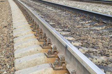Steel railway rails, concrete cross ties, gravel