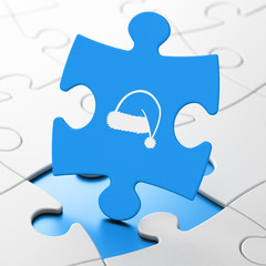 Fototapeta premium Entertainment, concept: Christmas Hat on puzzle background