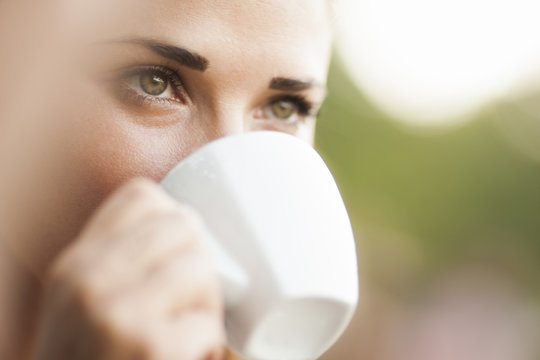 Close view of woman drinking coffee