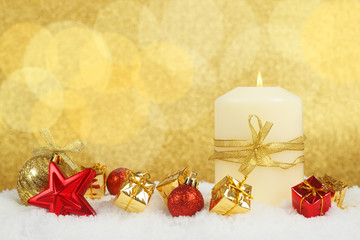 Christmas candle on snow