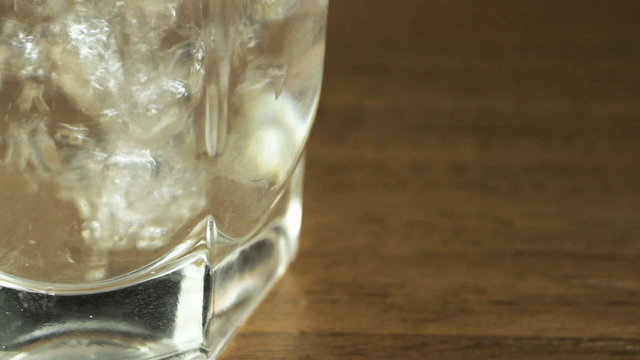Glass of water on a table, macro