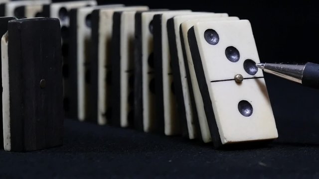 downfall of dominoes in slow motion