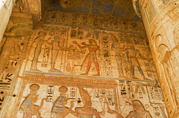 The hieroglyphs on the wall in Mortuary Temple of Ramesses III, Medinet Habu, Luxor, Egypt