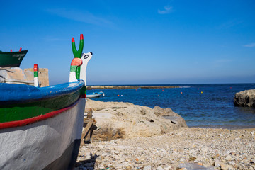 Bow of a small fishing boat on a beach of Polignano a Mare - Apulia, Italy