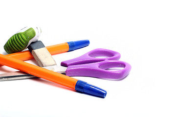 pen,scissors and eraser on a white background