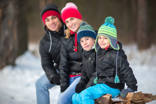 Happy family in the winter forest.