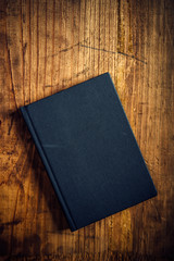 Black notebook on wooden office desk