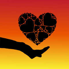 silhouette image of the hand on which is situated in the heart of an abstract background of a smooth transition of colors from red to yellow