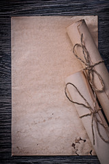 Heap of vintage rolled medieval paper on wooden board